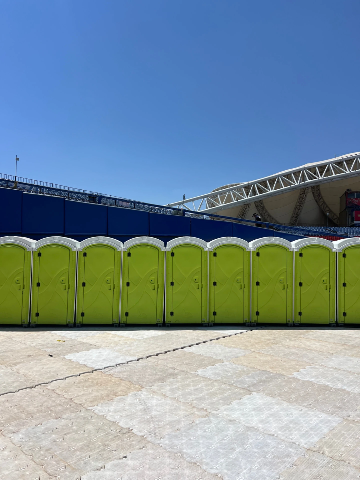 Green standard portable toilets installed at a mass outdoor event — Luvory