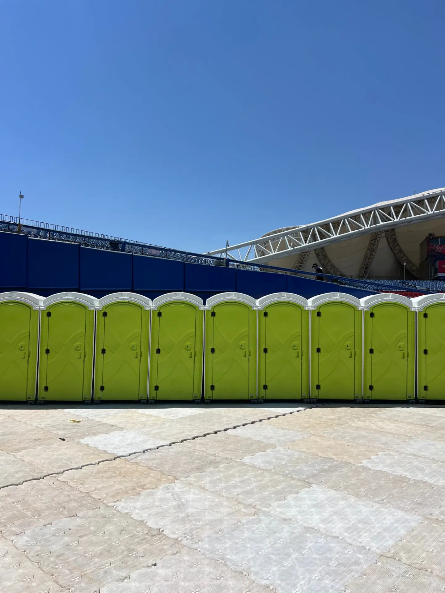 Green standard portable toilets installed at a mass outdoor event — Luvory